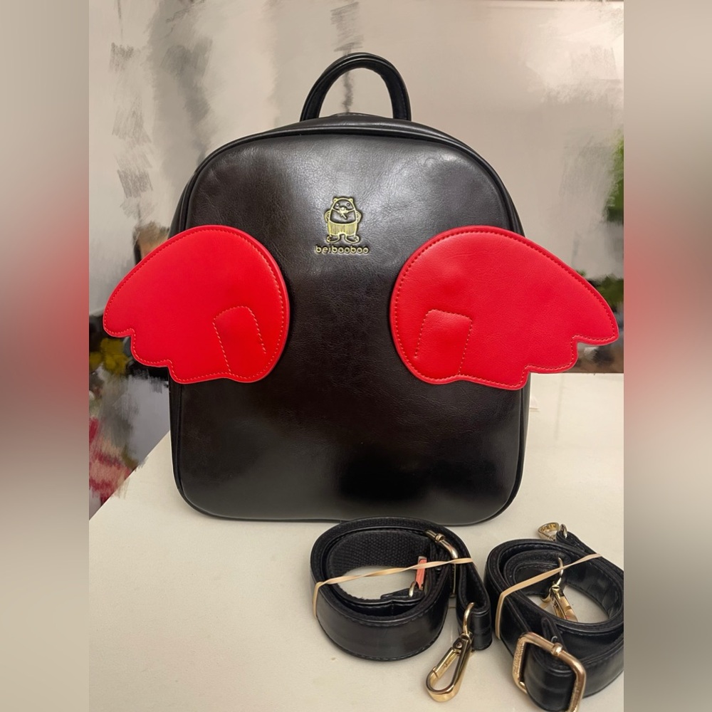 Cute Japanese/ Korean’ s style backpack, colour black with red and white wings.
